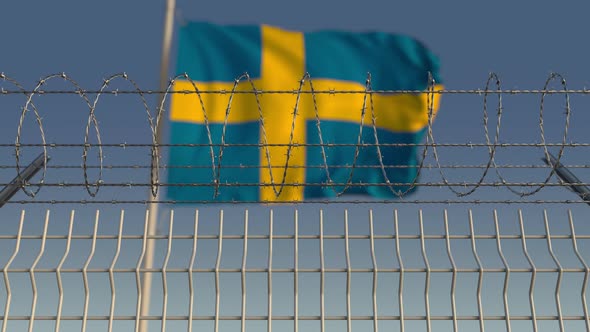 Barbed Wire Against Waving Flag of Sweden