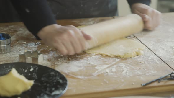 Woman rolling out dough for Christmas cookies