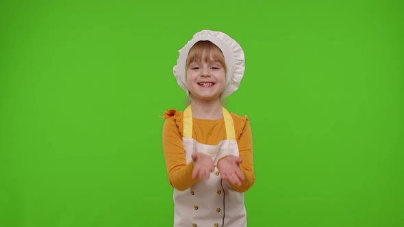 Child Girl Kid Dressed As Cook Chef Raising Hands Showing Tasty Gesture Smiling Looking at Camera