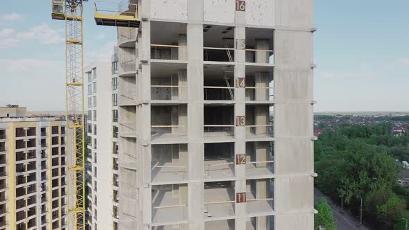 Aerial view of high residential apartment building under construction. Real estate development.