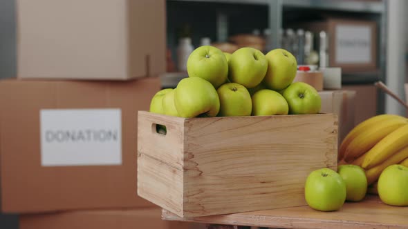 Wooden Boxes with Apples and Bananas in Charity Bank