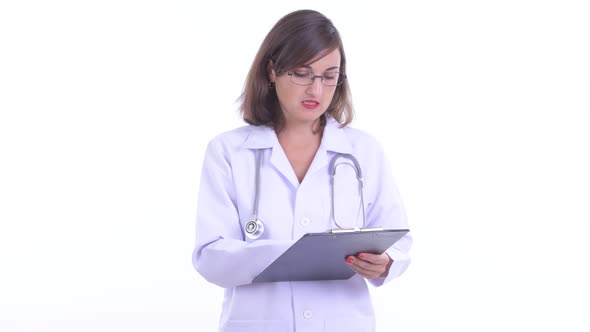 Happy Beautiful Woman Doctor Talking While Holding Clipboard