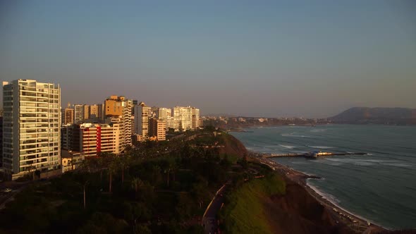 AERIAL - Beach and coastline in luxurious Miraflores, Lima, Peru, wide shot forward