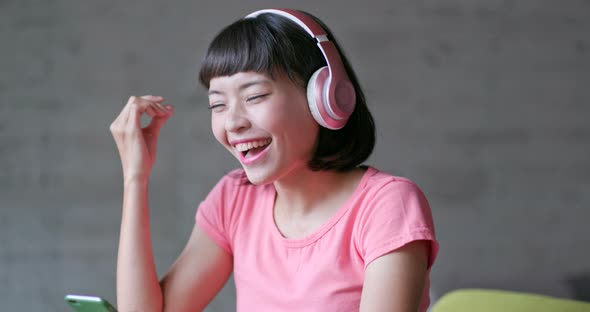 Woman enjoy music on headphone at home