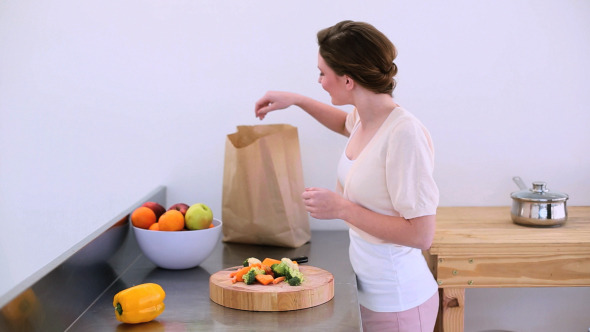 Pretty Model Standing In Kitchen With Peppers 2