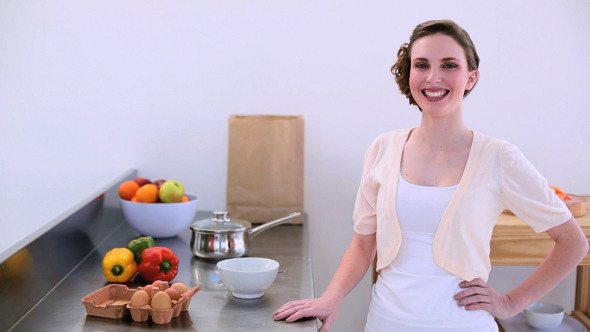 Pretty Model Standing In Kitchen Preparing Eggs