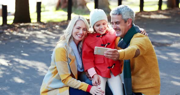 Parents and son taking a selfie on mobile phone