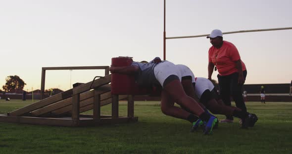 Young adult female rugby players training