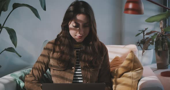 Woman looks up and ponders while working at home