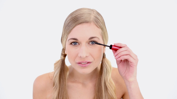 Happy Nude Blonde Applying Mascara