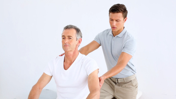 Physiotherapist Checking Senior Patient Stretching 1