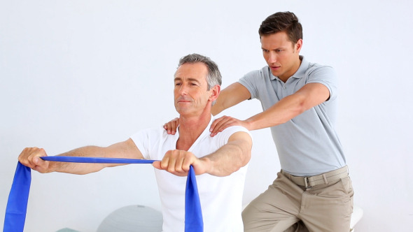 Physiotherapist Checking Senior Patient Stretching 2