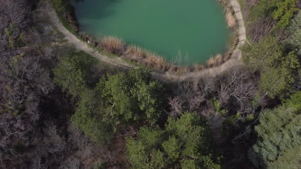 Aerial Top Down Flight Over Amazing Small Lake in Park Near Mountains