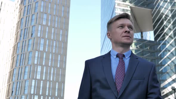 Young Businessman Walking in Business Center