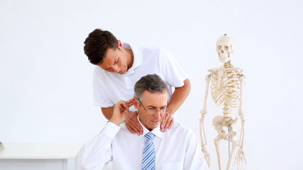 Physiotherapist Giving Businessman A Massage