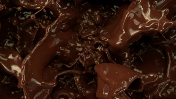 Super Slow Motion Shot of Splashing Melted Chocolate Background at 1000 Fps alt