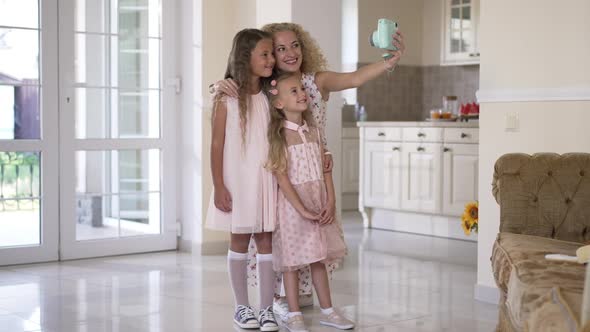 Wide Shot Happy Mother and Daughters Taking Selfie on Camera at Home in Living Room