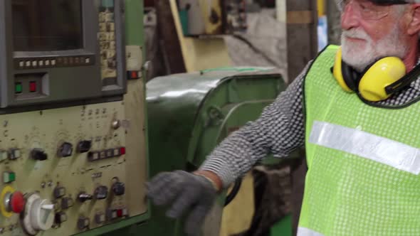 Senior Factory Worker Teach How to Use Machine Equipment in the Factory Workshop