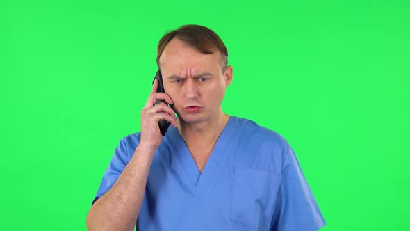 Medical Man Angrily Speaks on the Phone, Proves Something. Green Screen