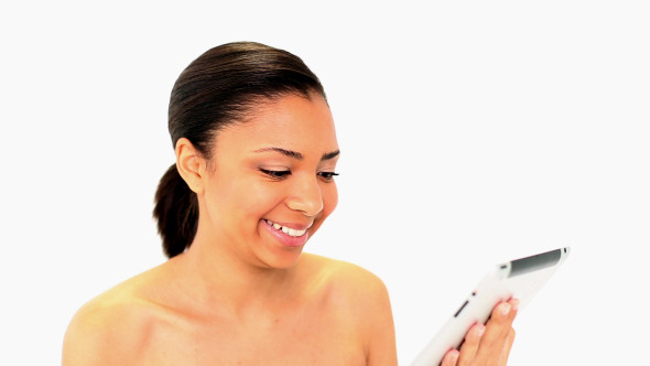 Gleeful Dark Haired Woman Using Her White Tablet