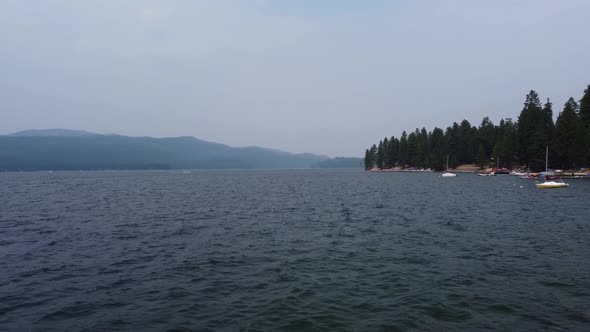 Drone zoom shot from a low angle a few feet above the water at Lake Payette in Idaho. This 4K cinema