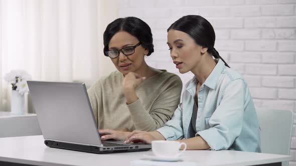 Girl Teaching Mother to Use Laptop, Showing Useful Software, Computer Literacy