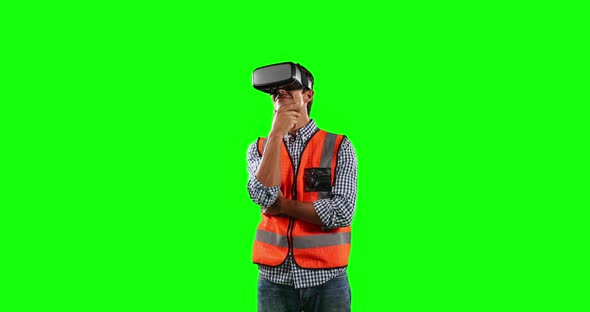 Front view of site worker using virtual reality with green screen