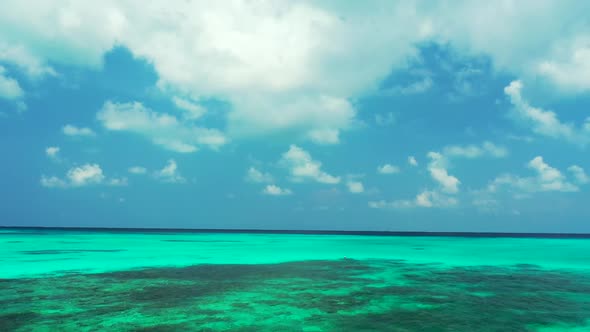 Aerial drone view seascape of beautiful seashore beach break by aqua blue lagoon with white sandy ba