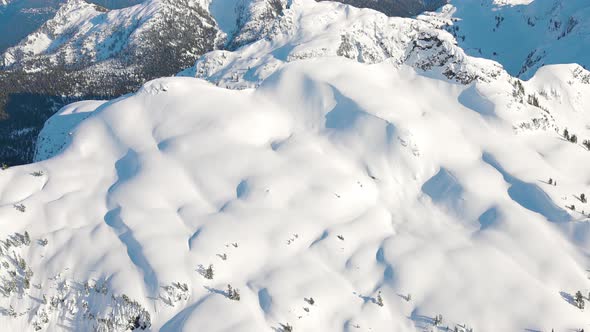 Aerial View From an Airplane of Beautiful Snowy Canadian Mountain Landscape