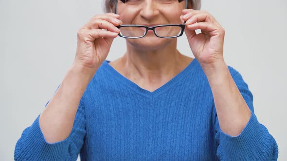 Portrait of Senior Woman Putting Her Glasses on 8