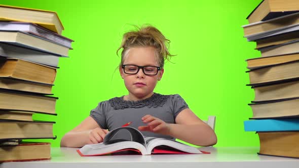 Girl Sitting and Leafing Through the Book. Green Screen. Slow Motion