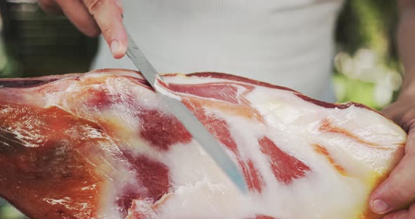 Man Slicing Jamon Leg