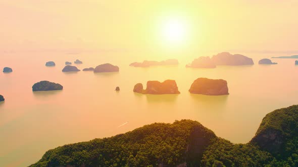 Aerial view from a drone over many islands at Phang Nga Bay during sunset time