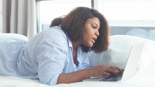 Frustrated Woman Staring at the Screen of Computer, Surprised Girl Using a Laptop.