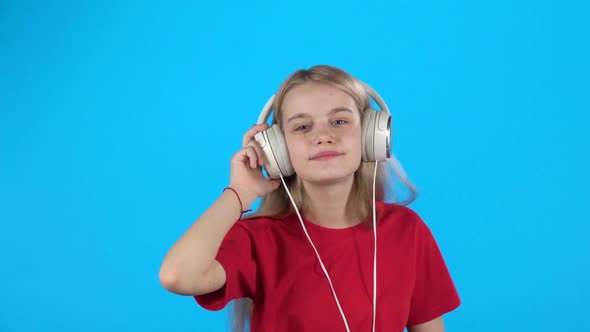 Teen Listening To Music in Big White Headphones, Singing and Dancing. Slow Motion