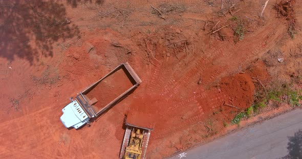 Heavy Construction Equipment Load Earth Into Dump Truck Using Excavators