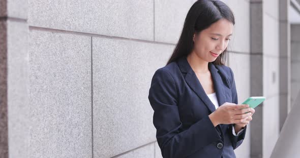 Business woman using mobile phone in the city 