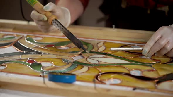 Skilled Workman Is Covering a Copper By Tin Solder on a Stained-glass