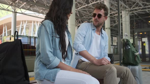 Travelling Couple Is Waiting Train at Station