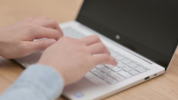 Close Up of Hands of Man Typing on Laptop