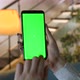 Chroma key mock-up on smartphone in hand. Woman holds mobile phone indoors of cozy home - VideoHive Item for Sale