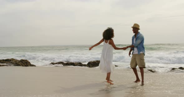 African American couple dancing together on the beach 4k