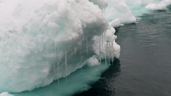 Dripping Icicles On Iceberg Over Sea