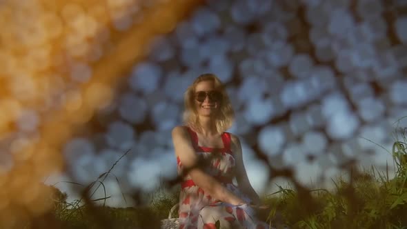 Woman with a straw hat and in red dress in hot summer day during vacation.