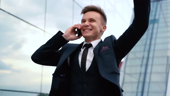 Happy Overjoyed Caucasian Businessman Celebrate Good News Surprise at at Work with Modern Office