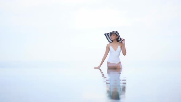 Young asian woman enjoy around outdoor swimming pool for leisure