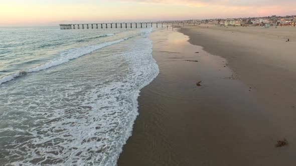 Aerial shot of young man running on the beach.