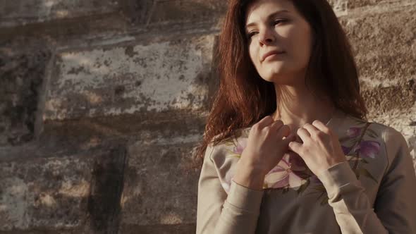 Woman Standing By the Giant Stone Wall