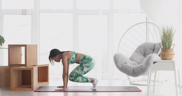 Black woman in sportswear doing workout burning fat calories .