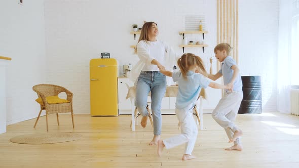 Active Family Mother and Kids Dancing Around and Jumping Love and Friendship